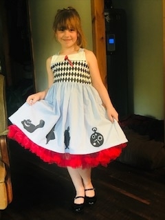 Tia is dressed as Alice from Alice in Wonderland .